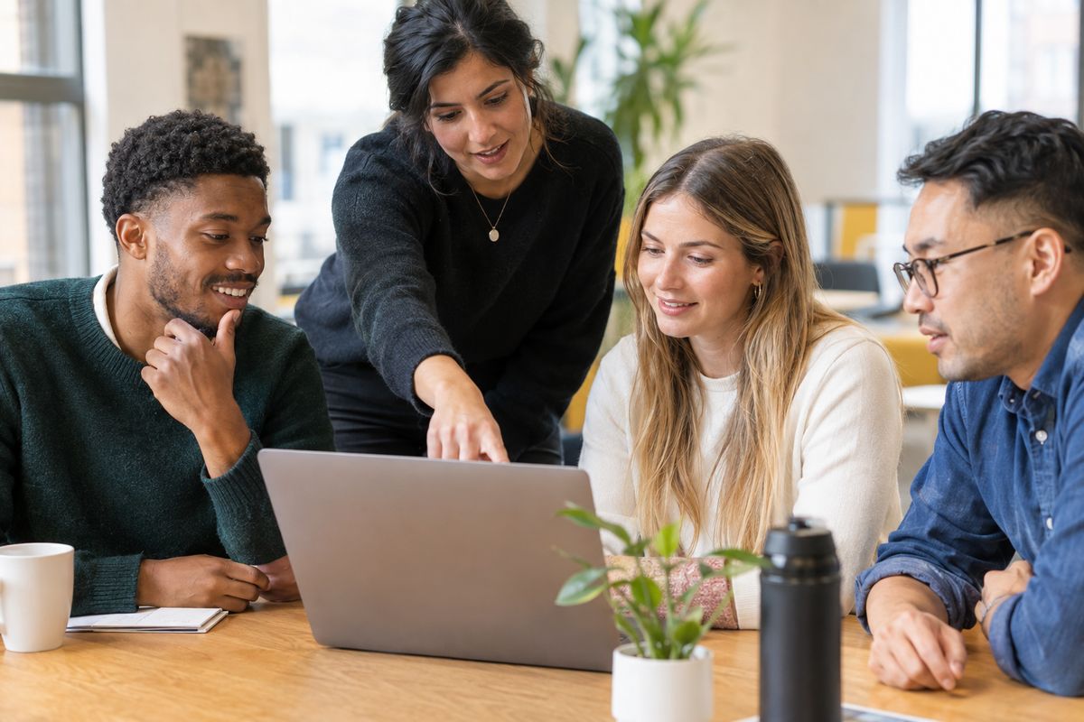 An office team working through the accounts at a laptop
